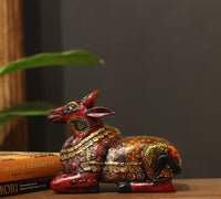 Wooden Nandi statue side view – vibrant hand-painted floral motifs India