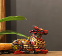 Intricate hand-painted floral motifs on wooden Nandi statue – CottageArts India