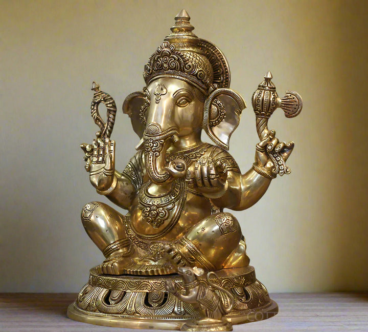 Decorative gold statue of a deity with intricate details .